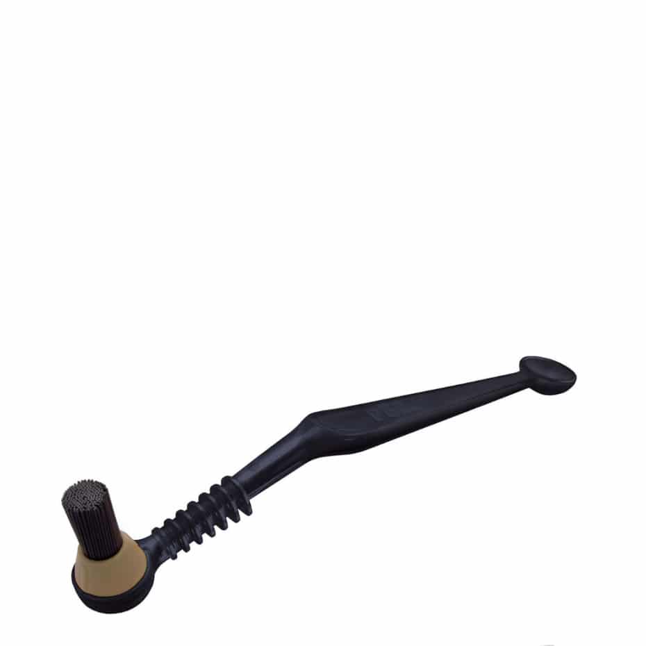 A black Pallo Gasket Brush, with scrubbing bristles on one end and a small scoop on the opposing end.