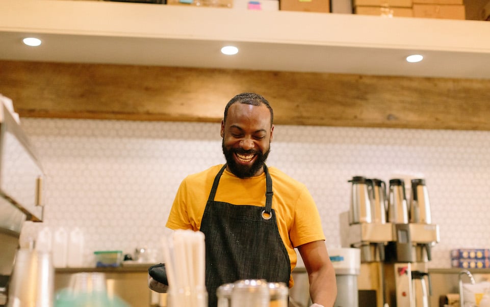 El smiles while working behind the bar at Blueprint Coffee Delmar