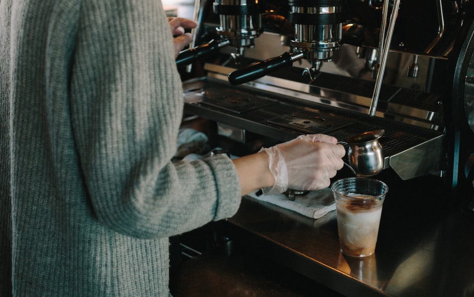 MG makes an iced dirty chai in front of the espresso machine
