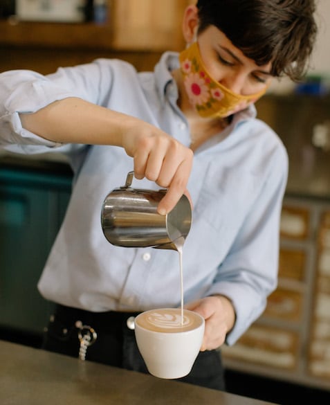 Mac pours a latte