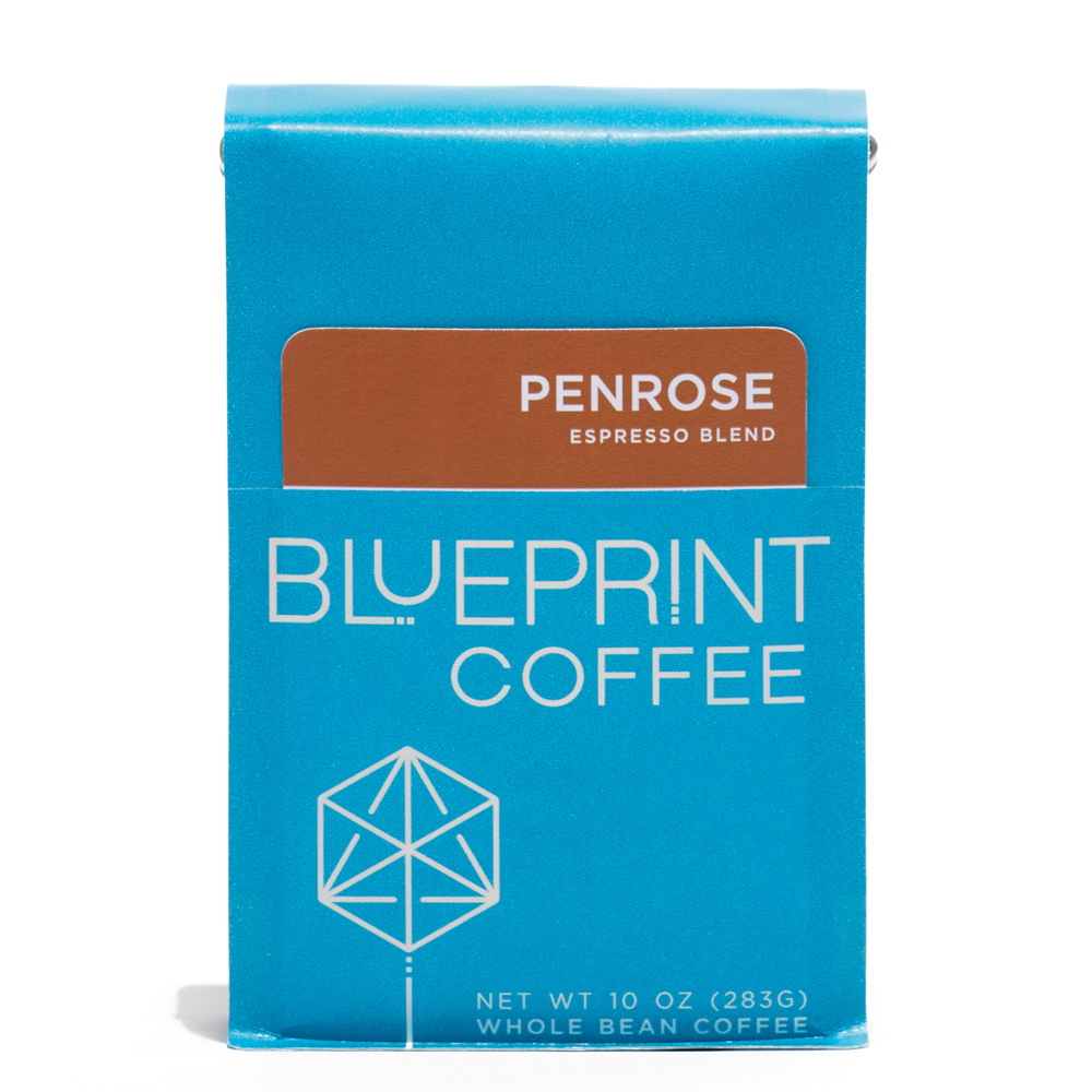 A blue 10-ounce bag of Penrose Espresso coffee beans featuring the Blueprint Coffee Logo and a removable info card.
