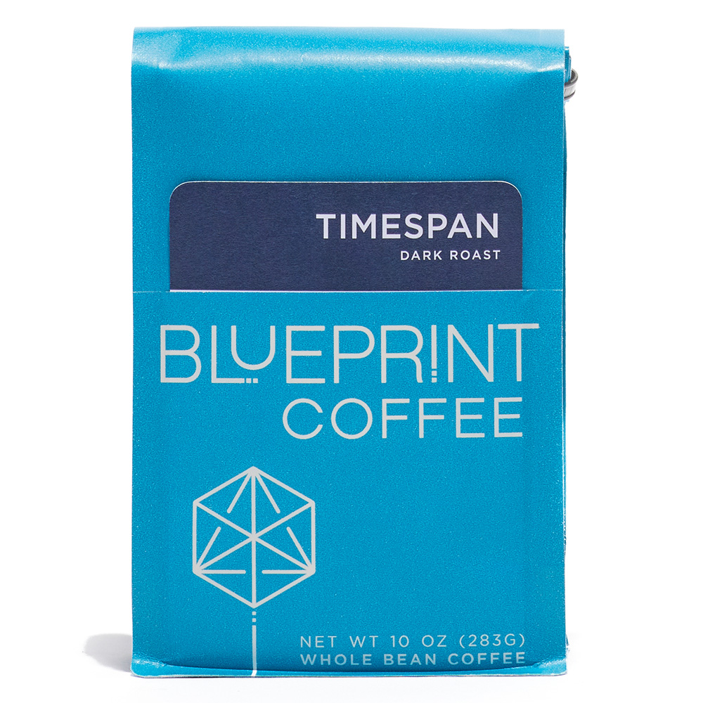 A blue 10-ounce bag of Timespan (dark roast) coffee beans featuring the Blueprint Coffee Logo and a navy blue removable info card.