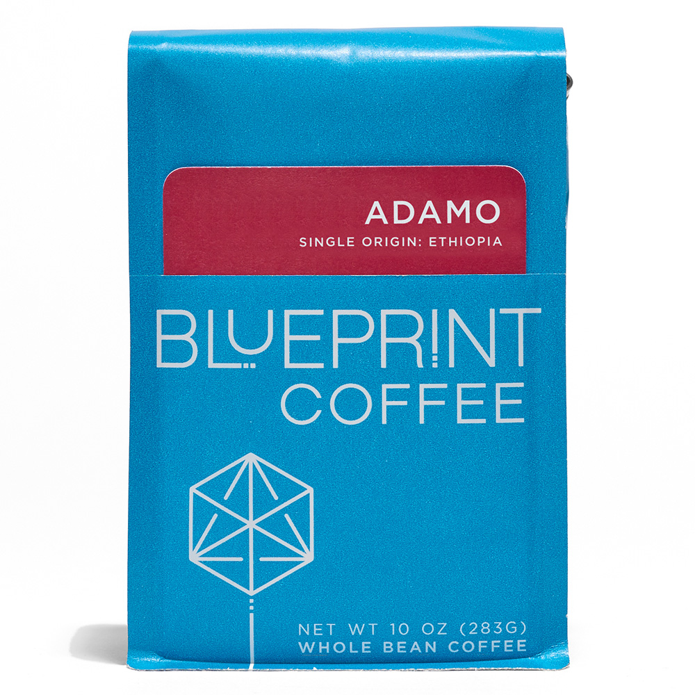 A blue 10-ounce bag of Adamo, Ethiopia coffee beans featuring the Blueprint Coffee Logo and a red removable info card.